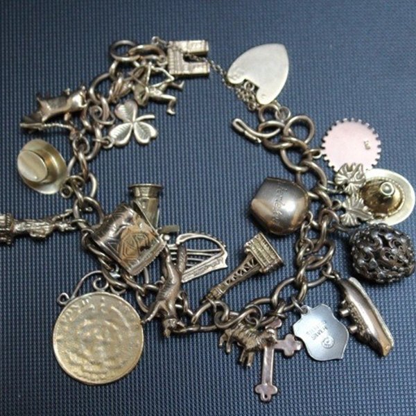Golden charm bracelet with various small pendants.
