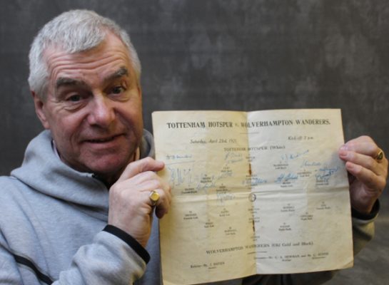 Man holding signed 1951 Tottenham Hotspur program.