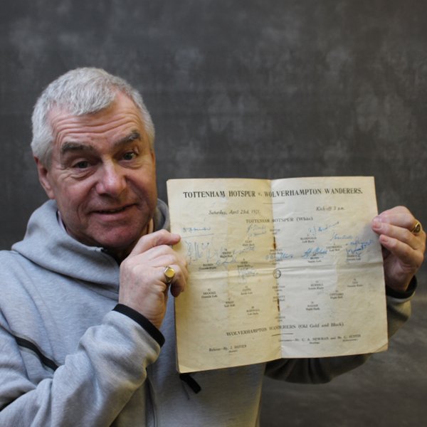 Man holding signed 1951 Tottenham Hotspur program.